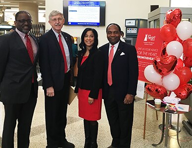 Photo of Dr. Griffen P. Rodgers and fellow NIH leaders wearing red to commemorate National Wear Red Day, part of American Heart Month