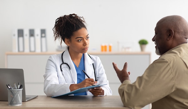 A general practitioner speaking with a patient