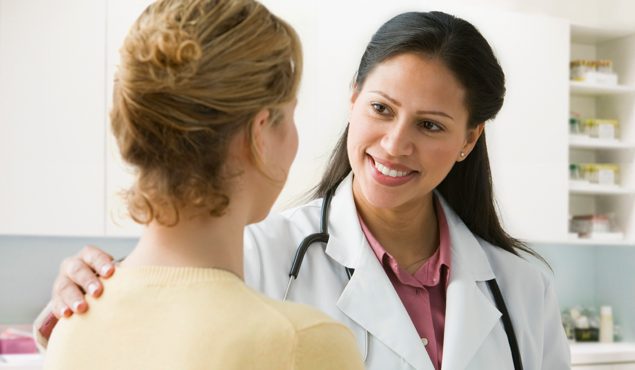 A health care professional speaking with a patient. 