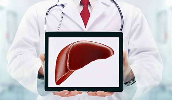 A doctor holding an iPad with an image of a liver.