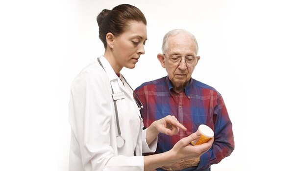 Physician discussing medication label with patient in a one on one setting.