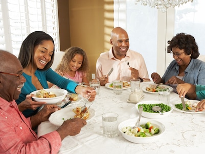 A multigenerational family eating dinner together.