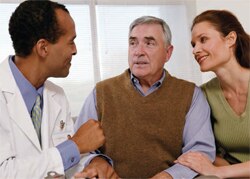 Older man and a younger woman talking to a doctor