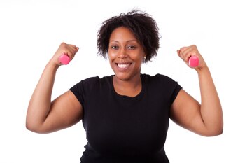 Photo of a smiling woman holding hand weights.