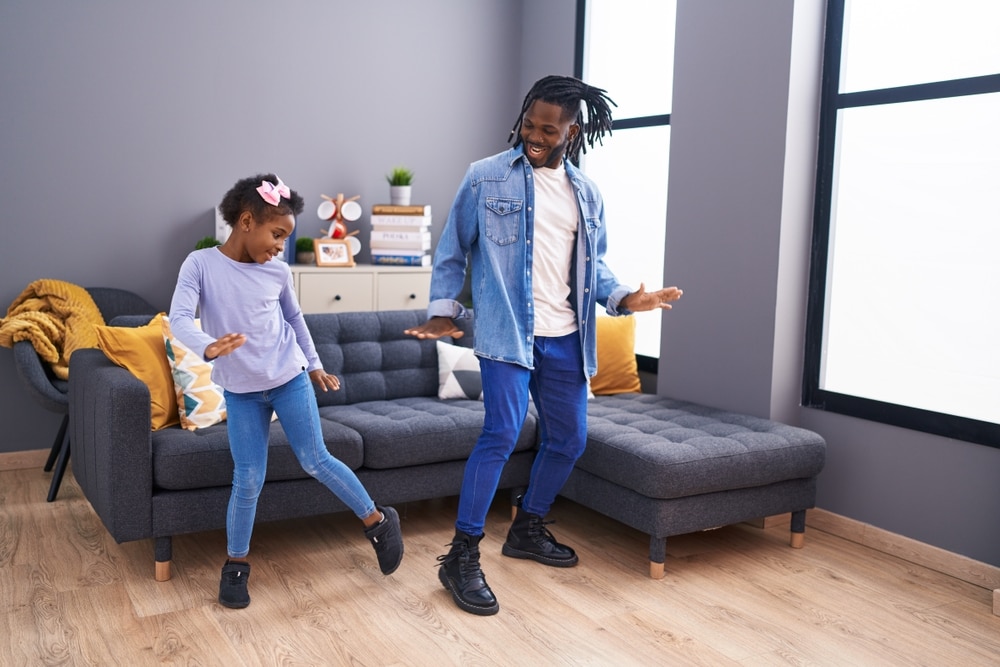 Father and daughter dancing together.