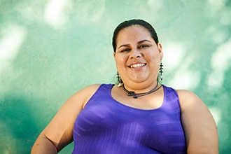 An overweight Hispanic woman smiling