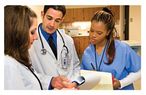 Health care professionals review test results in a clinical setting.