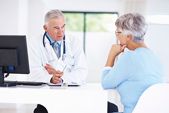 Middle-aged woman having a conversation with her doctor in the doctor’s office.