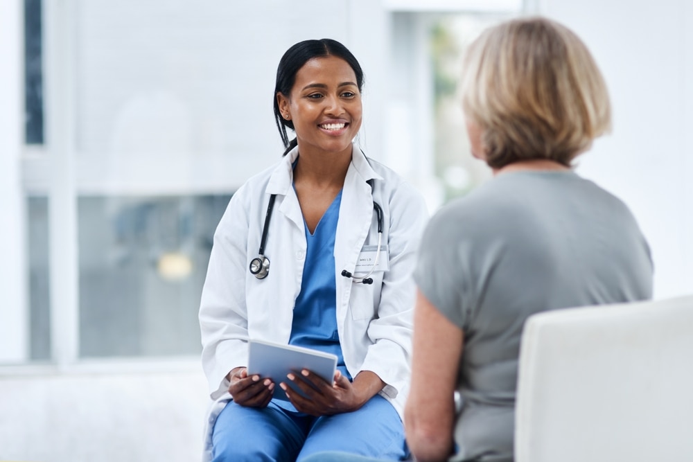 A patient and doctor sitting and talking.