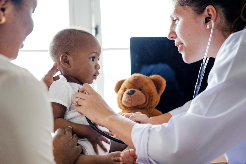 Pediatrician examining an infant.