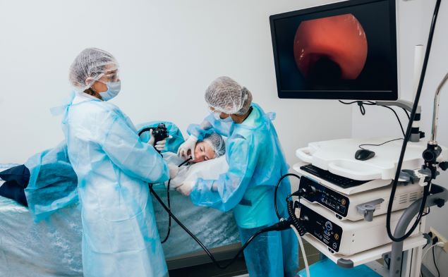 Health care professionals performing an upper GI endoscopy.
