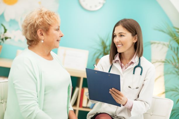 Doctor talking with an older female patient.