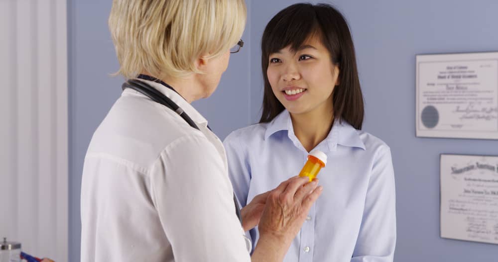 A doctor talking with a patient about a prescription medicine.