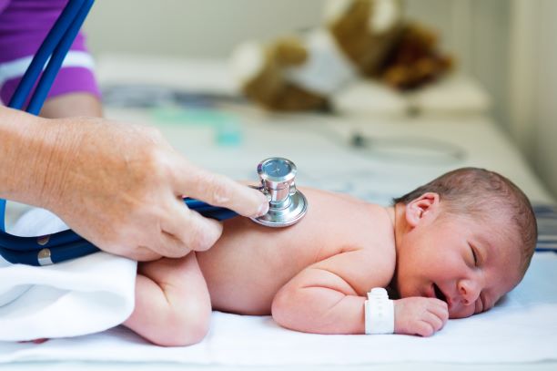 Newborn baby being examined by a health care professional.