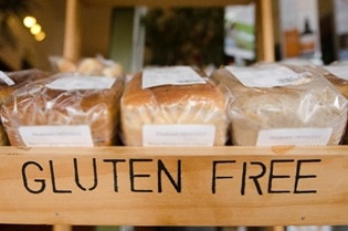Shelf of gluten-free bread at a grocery store.