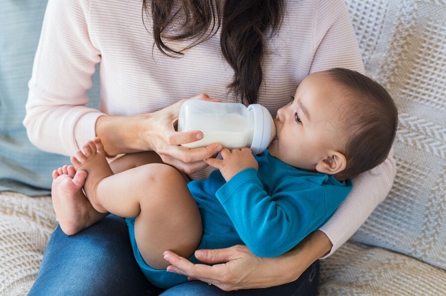 Mother feeding infant with a bottle