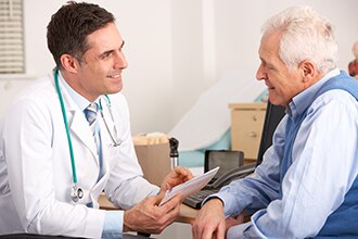 Health care professional speaking with a patient and sharing a document