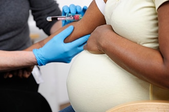 Pregnant woman having her blood drawn