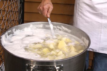 Diced potatoes boiling in a pot of water.
