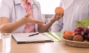 A dietitian discusses healthy eating habits and how to plan meals with a patient.
