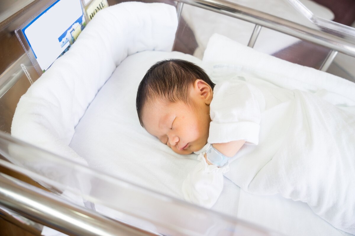 A baby in a hospital bassinet.