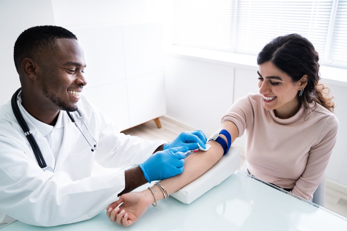 A health care professional taking a blood sample from a patient.