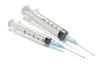 Two syringes with needles.