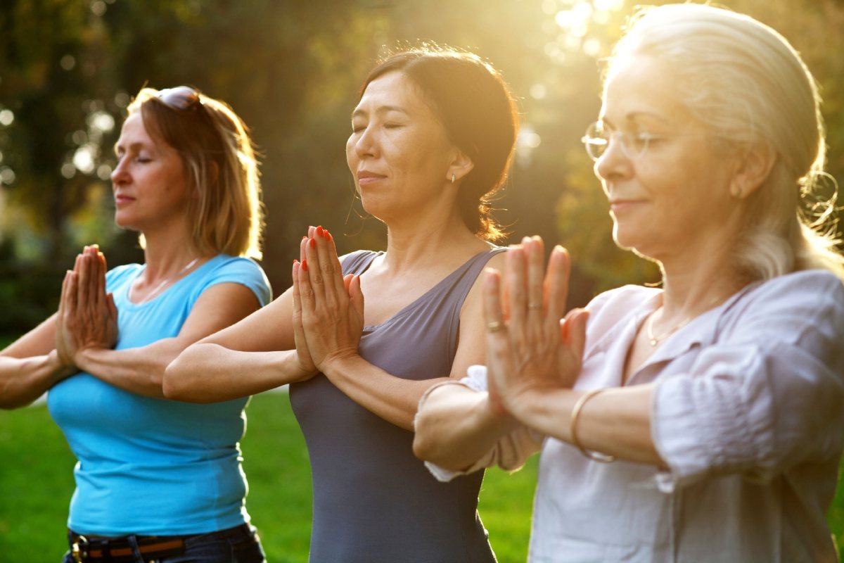 Women doing yoga outside.