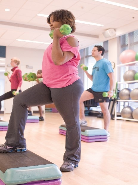 A woman lifting weights in an exercise class