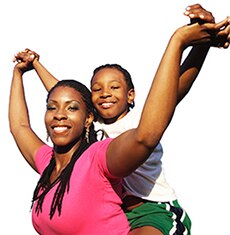 African American mom in pink shirt with kid on her back.