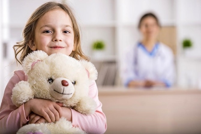 A child hugging her teddy bear