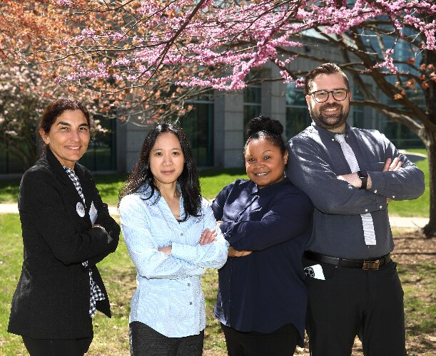 Lorraine Moore, Christine Krieger, Sandy Redman-Gomez, and Angel de la Cruz standing outside and smiling.