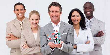 Five professionals with one holding a model of a molecule