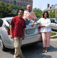Group photo on car with licence plate reading NTHROSE
