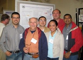 Photo of team in front of poster at the 2009 Gordon Research Conference