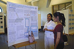 Photo of Rina Saksena explaining her poster at the 2003 Gordon Research Conference