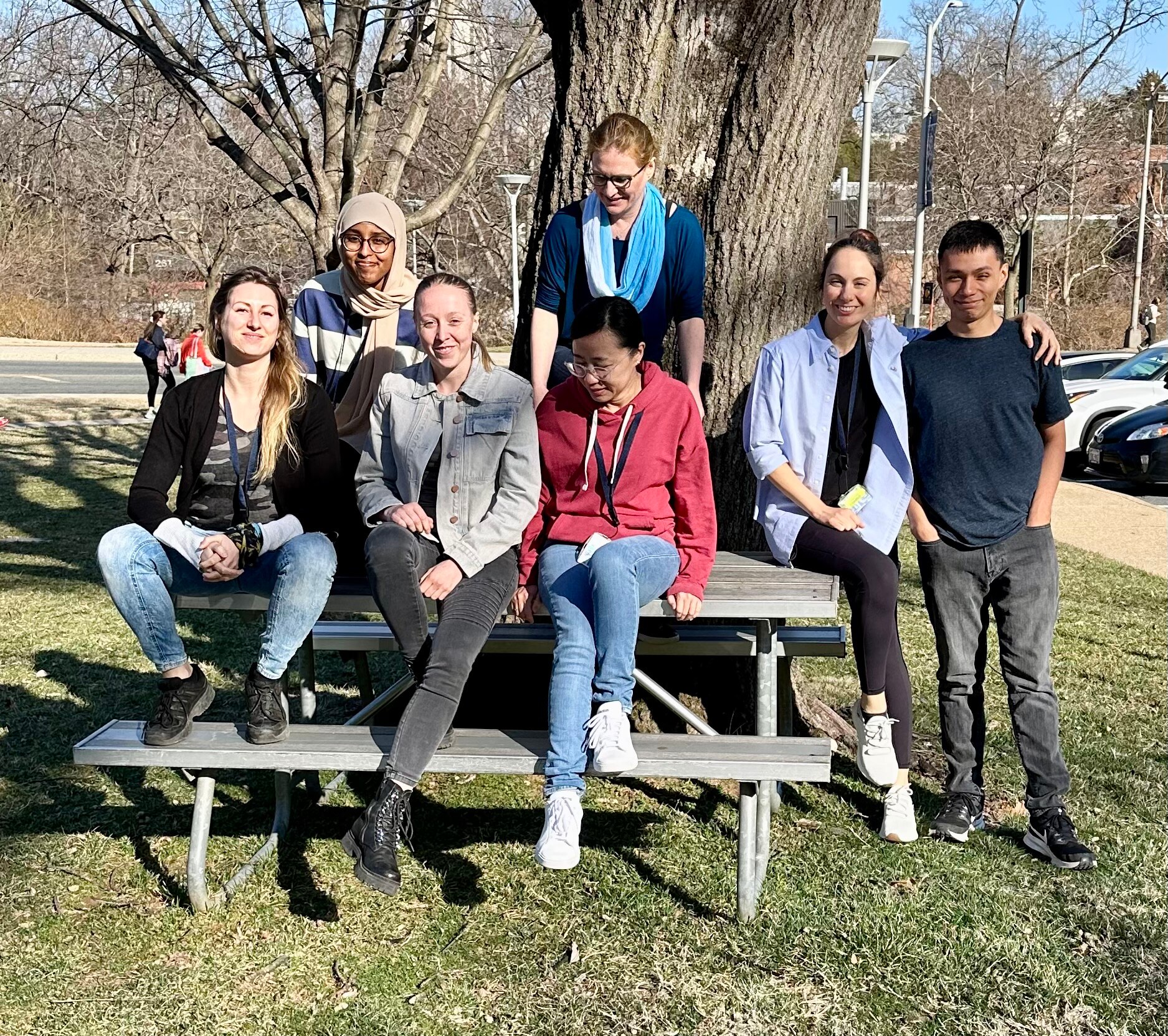 RNA Biology Section lab members outdoors standing in front of a tree.