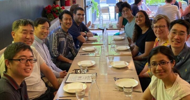 Lab members sitting at a long table