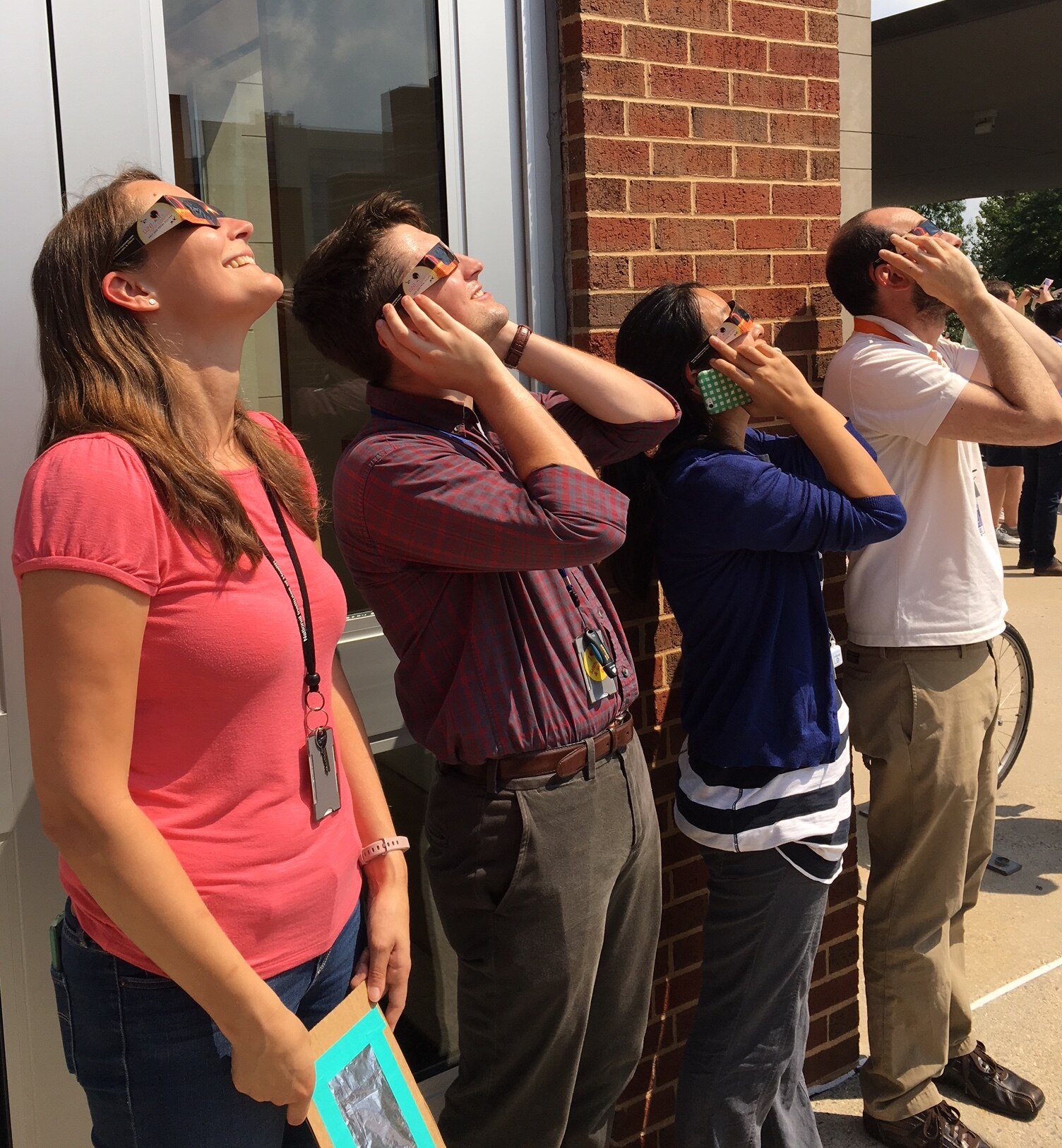 Lab members looking at a solar eclipse.